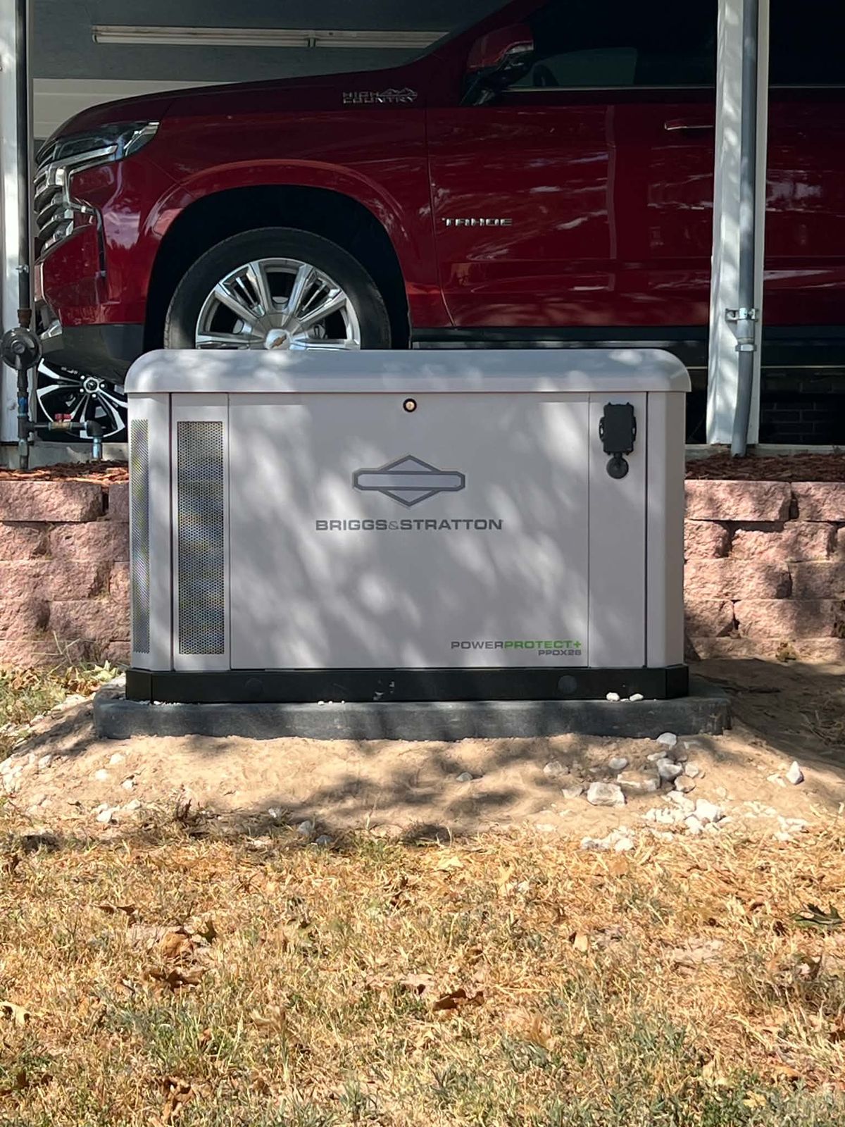 Briggs and Stratton standby generator in front of a carport