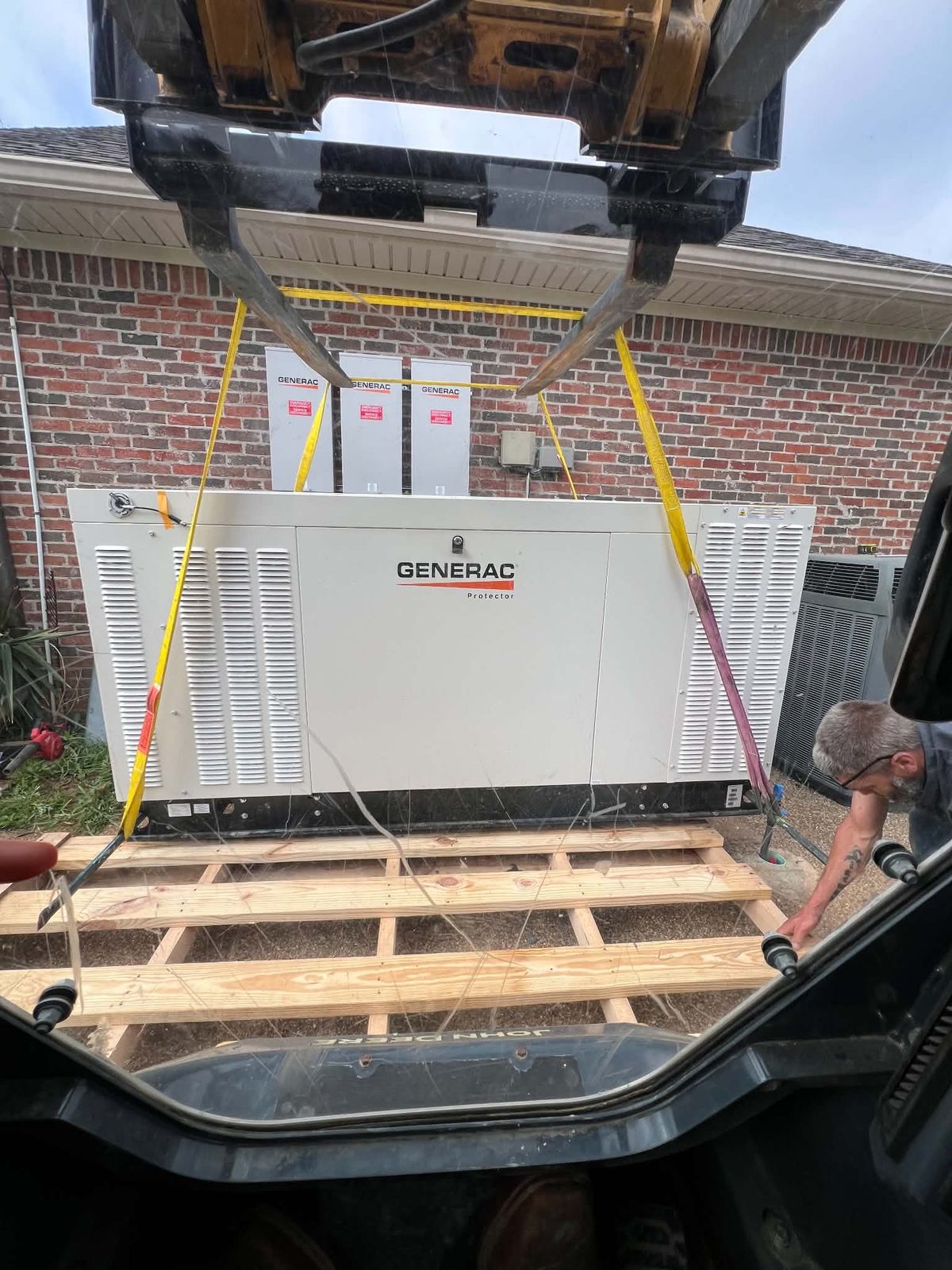 Generac generator being lifted into place by crane