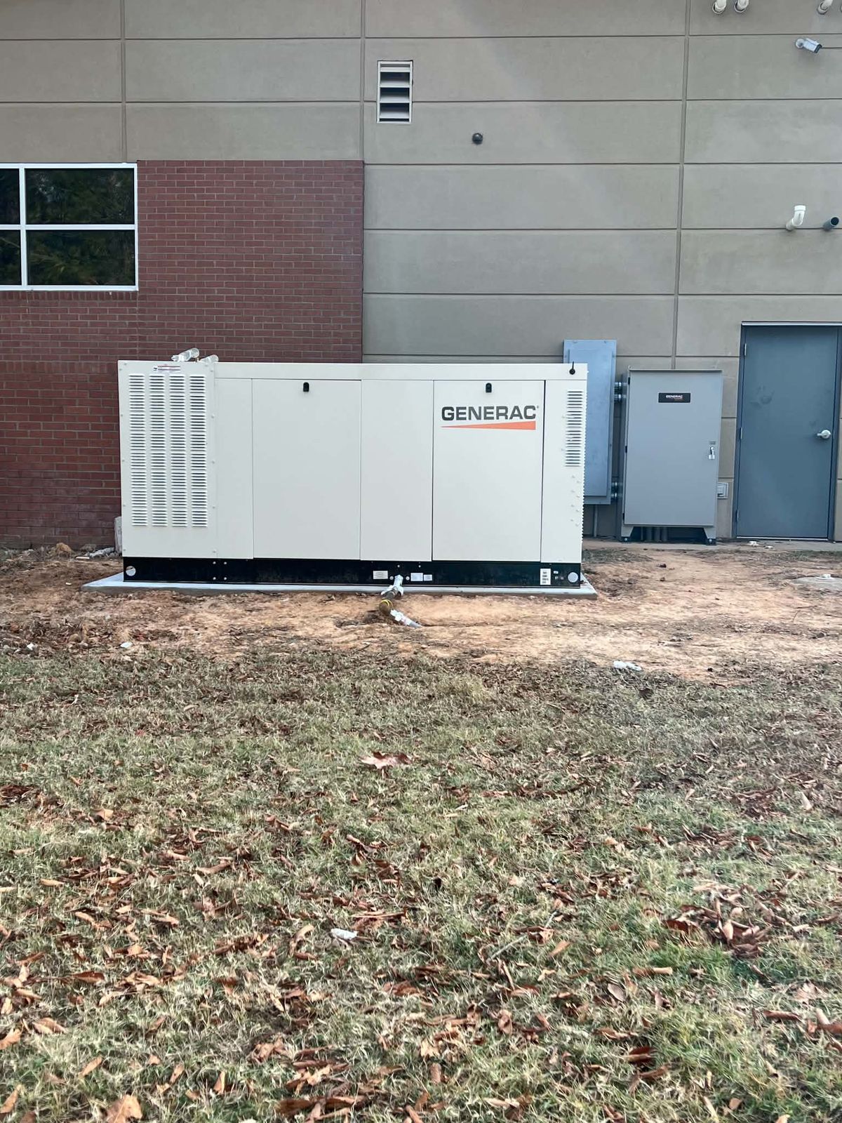 Commercial Generac generator installed beside a business building